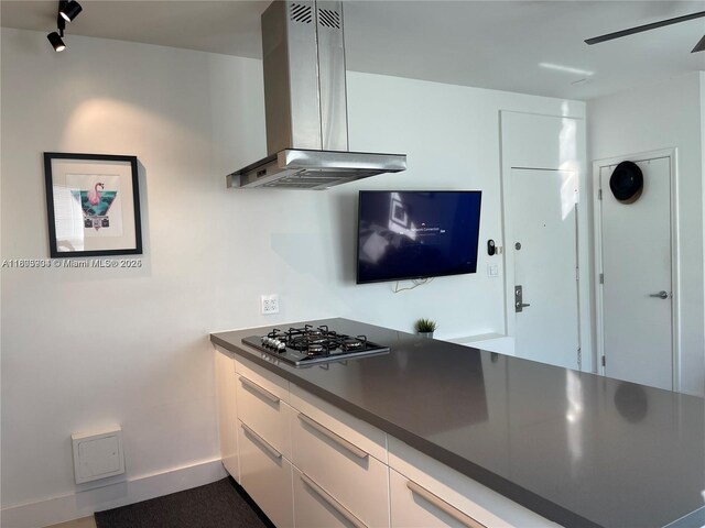 1618 Michigan Ave Unit 26, Miami Beach, FL 33139 - kitchen with exhaust hood, stainless steel gas cooktop, dark countertops, white cabinets, and modern cabinets
