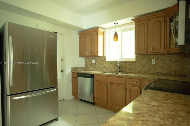 8851 Byron Ave, Surfside, FL 33154 - kitchen with stainless steel appliances, tasteful backsplash, light tile patterned floors, light stone counters, and pendant lighting