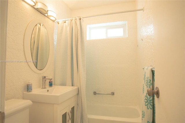 8851 Byron Ave, Surfside, FL 33154 - bathroom featuring a textured wall and shower / bath combo with shower curtain