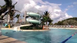 8851 Byron Ave, Surfside, FL 33154 - community pool featuring a water slide