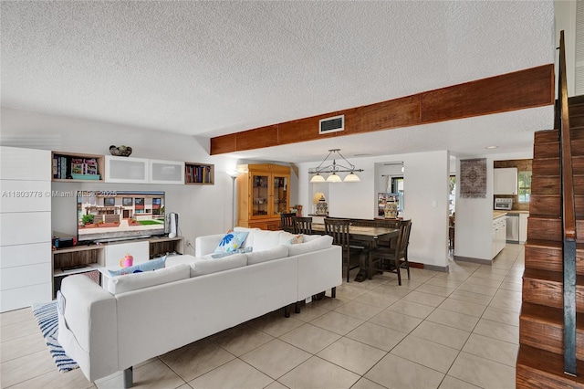 16465 NE 26th Ave Unit 18, North Miami Beach, FL 33160 - living area featuring a textured ceiling and light tile patterned flooring