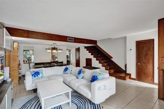 16465 NE 26th Ave Unit 18, North Miami Beach, FL 33160 - living area with stairs, light tile patterned flooring, and a textured ceiling