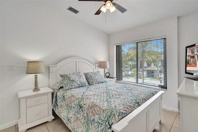 16465 NE 26th Ave Unit 18, North Miami Beach, FL 33160 - bedroom with light tile patterned floors, baseboards, a ceiling fan, and a textured ceiling