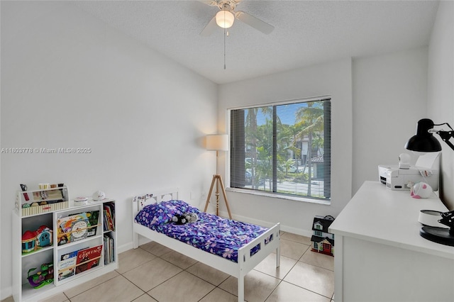 16465 NE 26th Ave Unit 18, North Miami Beach, FL 33160 - bedroom with light tile patterned floors, baseboards, a textured ceiling, and ceiling fan