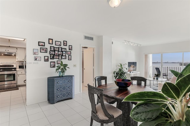 300 Bayview Dr Unit 812, Sunny Isles Beach, FL 33160 - dining area with rail lighting and light tile patterned flooring