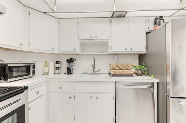 300 Bayview Dr Unit 812, Sunny Isles Beach, FL 33160 - kitchen featuring appliances with stainless steel finishes, a sink, light countertops, and white cabinetry