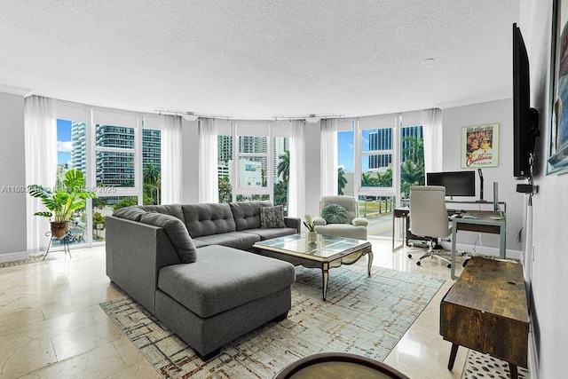 living area with a textured ceiling, an office area, a wall of windows, and baseboards