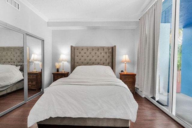 bedroom featuring ornamental molding, access to outside, and wood finished floors