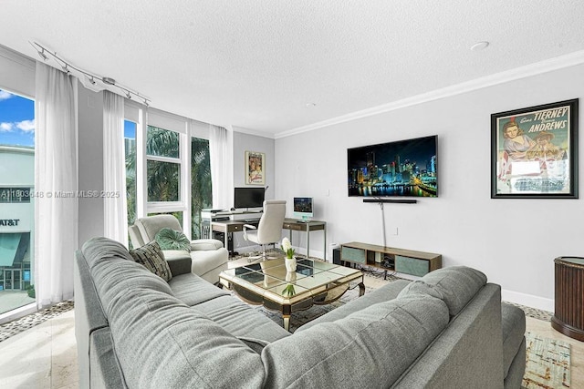 living area with a textured ceiling, ornamental molding, baseboards, and a desk