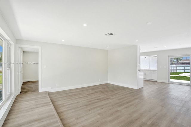 2021 N 53rd Ave, Hollywood, FL 33021 - empty room featuring light wood-style floors, baseboards, recessed lighting, and a sink