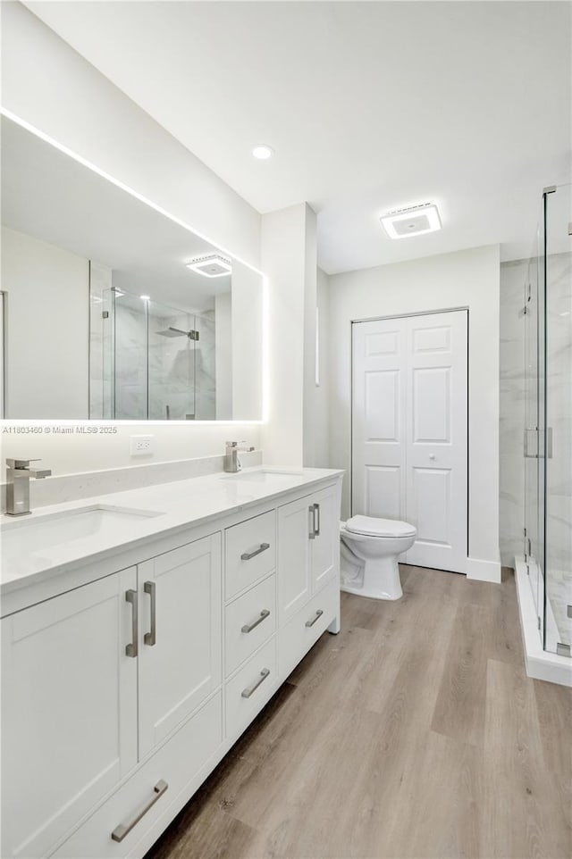 2021 N 53rd Ave, Hollywood, FL 33021 - full bathroom featuring a shower stall, wood finished floors, double vanity, and toilet