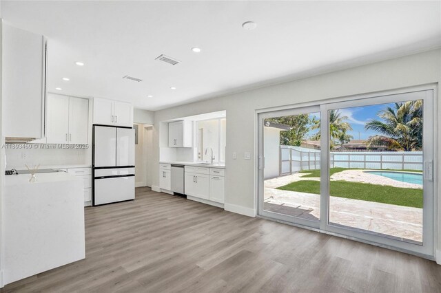 2021 N 53rd Ave, Hollywood, FL 33021 - kitchen featuring freestanding refrigerator, stainless steel dishwasher, light countertops, light wood-style floors, and recessed lighting