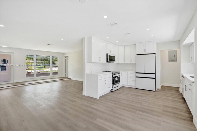2021 N 53rd Ave, Hollywood, FL 33021 - kitchen with appliances with stainless steel finishes, baseboards, open floor plan, light wood-style floors, and recessed lighting