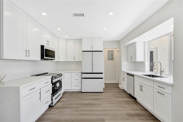 2021 N 53rd Ave, Hollywood, FL 33021 - kitchen with appliances with stainless steel finishes, a sink, white cabinetry, and recessed lighting