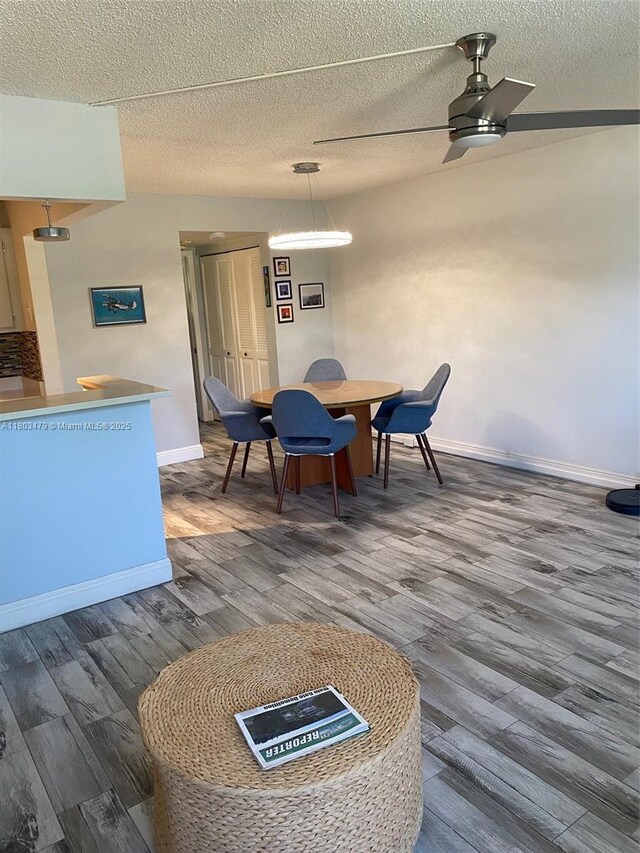 172 Prescott I 172, Deerfield Beach, FL 33442 - dining area featuring wood finished floors, baseboards, a textured ceiling, and a ceiling fan