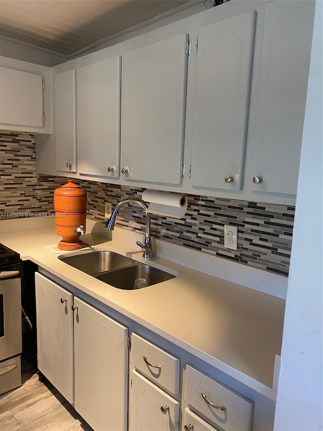 172 Prescott I 172, Deerfield Beach, FL 33442 - kitchen featuring a sink, backsplash, stove, and light countertops