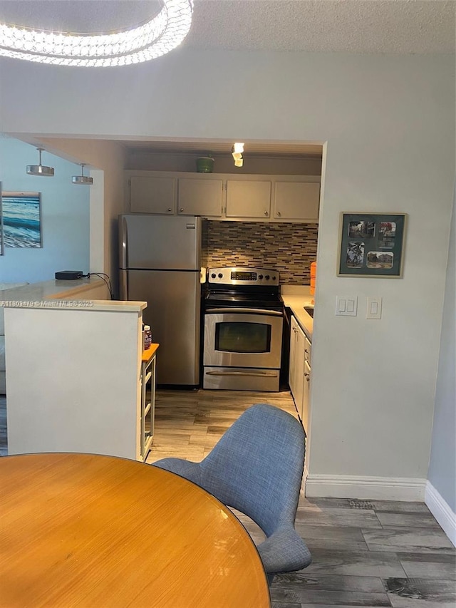 172 Prescott I 172, Deerfield Beach, FL 33442 - kitchen featuring stainless steel appliances, light countertops, tasteful backsplash, baseboards, and light wood finished floors