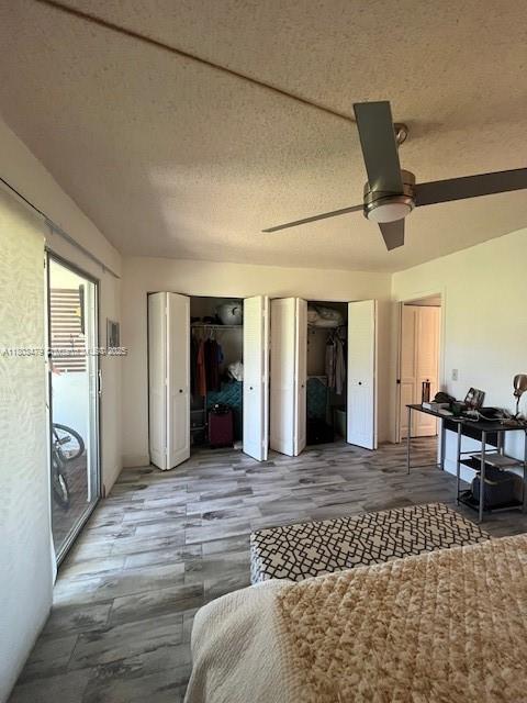 172 Prescott I 172, Deerfield Beach, FL 33442 - bedroom with multiple closets, wood finished floors, and ceiling fan
