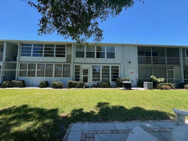 172 Prescott I 172, Deerfield Beach, FL 33442 - back of property featuring a yard and central air condition unit