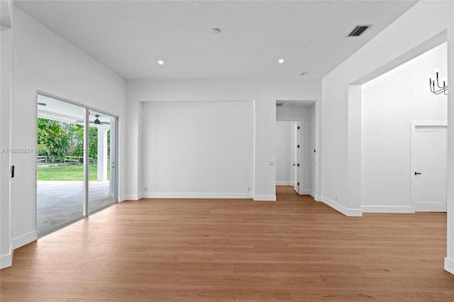 empty room featuring light wood finished floors, recessed lighting, and baseboards