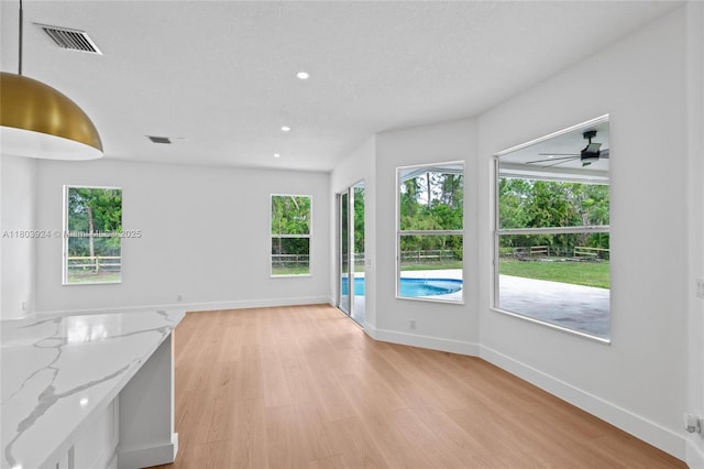 empty room featuring light wood-style flooring, baseboards, recessed lighting, and a ceiling fan