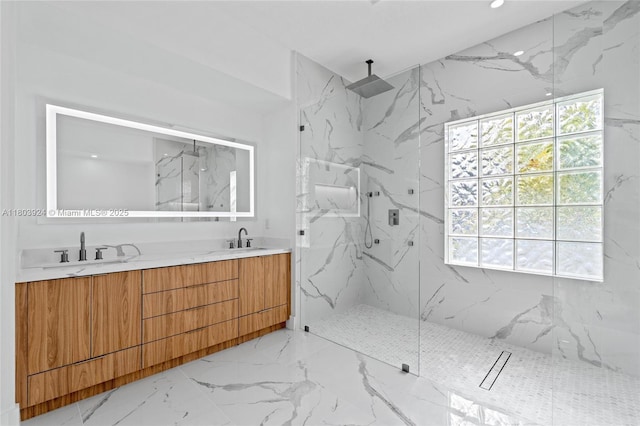 full bathroom featuring a marble finish shower, marble tiled flooring, and double vanity