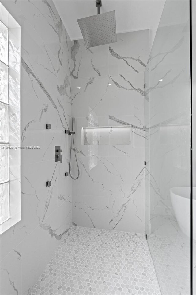 bathroom with a marble finish shower