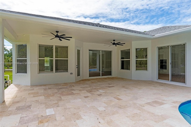 view of patio featuring ceiling fan and an outdoor pool