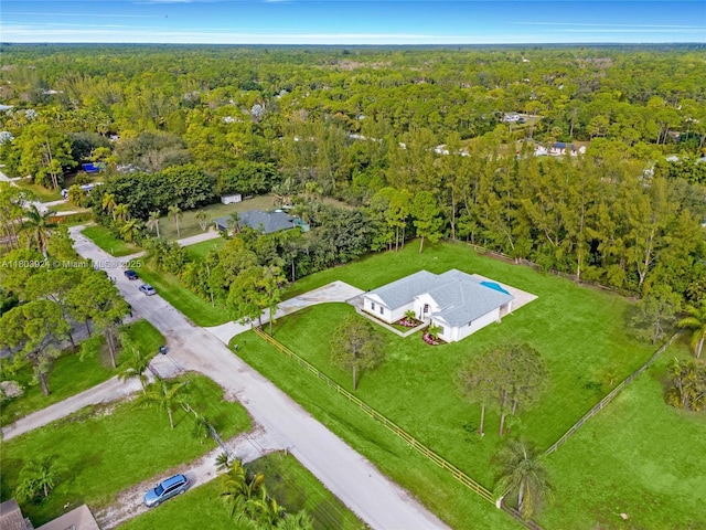 aerial view of property and surrounding area with a forest