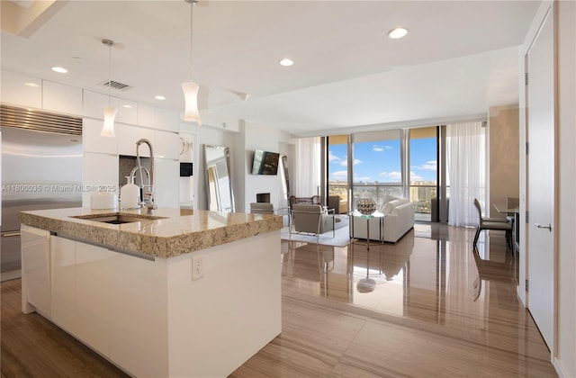 9705 Collins Ave Unit 1805N, Bal Harbour, FL 33154 - kitchen with modern cabinets, stainless steel built in refrigerator, white cabinets, a sink, and a wall of windows