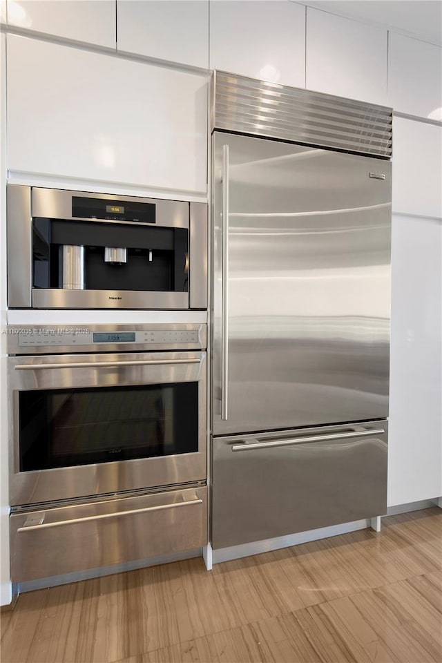 9705 Collins Ave Unit 1805N, Bal Harbour, FL 33154 - kitchen with appliances with stainless steel finishes, a warming drawer, white cabinets, and modern cabinets