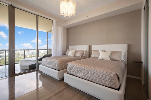 9705 Collins Ave Unit 1805N, Bal Harbour, FL 33154 - bedroom with access to outside, a chandelier, wood finished floors, baseboards, and expansive windows