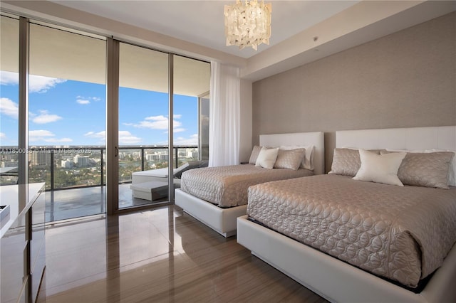 9705 Collins Ave Unit 1805N, Bal Harbour, FL 33154 - bedroom with a chandelier, access to exterior, and wood finished floors