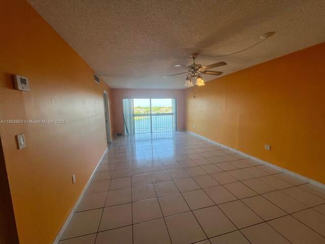 10290 NW 9th St Cir Unit 512, Miami, FL 33172 - unfurnished room featuring ceiling fan, light tile patterned flooring, a textured ceiling, and baseboards