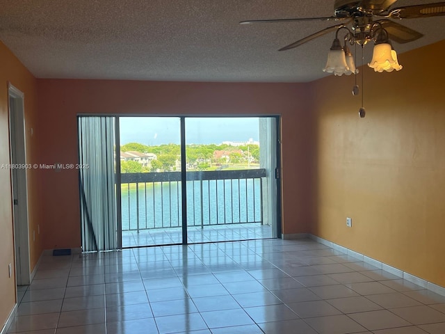 10290 NW 9th St Cir Unit 512, Miami, FL 33172 - empty room featuring plenty of natural light, ceiling fan, light tile patterned flooring, and a textured ceiling