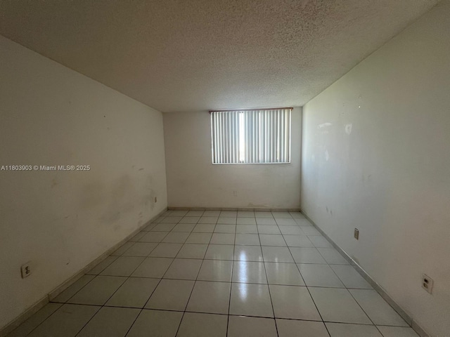 10290 NW 9th St Cir Unit 512, Miami, FL 33172 - unfurnished room featuring a textured ceiling, light tile patterned floors, and baseboards