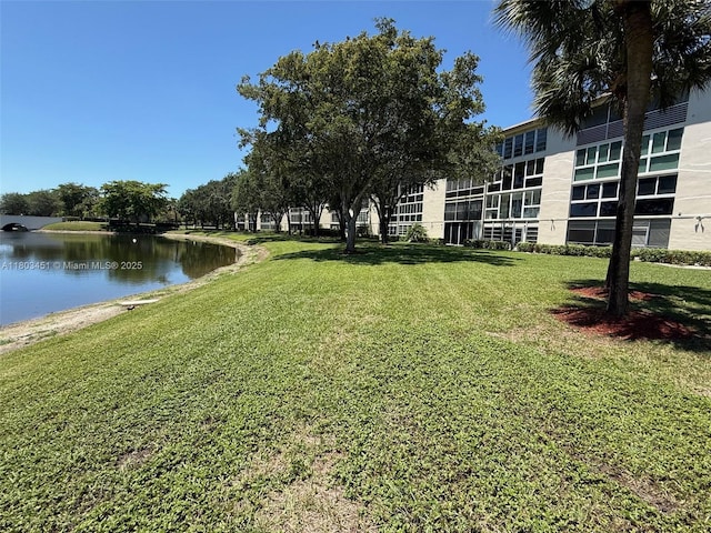2305 Lucaya Ln Unit H1, Coconut Creek, FL 33066 - surrounding community featuring a water view and a lawn
