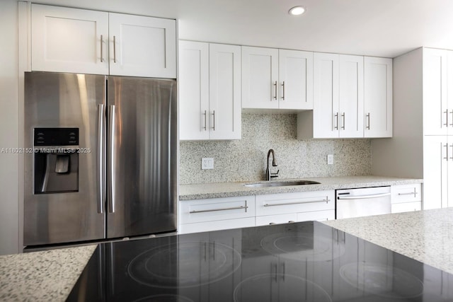 4280 Galt Ocean Dr Unit 23A, Fort Lauderdale, FL 33308 - kitchen featuring stainless steel fridge, a sink, dishwashing machine, white cabinetry, and light stone countertops