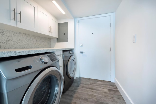 4280 Galt Ocean Dr Unit 23A, Fort Lauderdale, FL 33308 - clothes washing area with separate washer and dryer, electric panel, cabinet space, and wood finished floors
