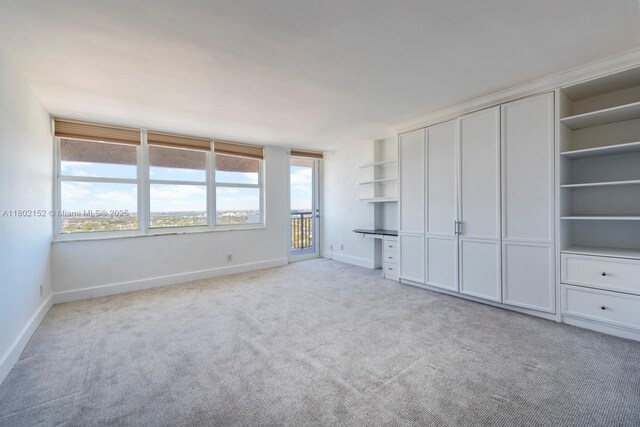 4280 Galt Ocean Dr Unit 23A, Fort Lauderdale, FL 33308 - unfurnished bedroom featuring light colored carpet, baseboards, and multiple windows