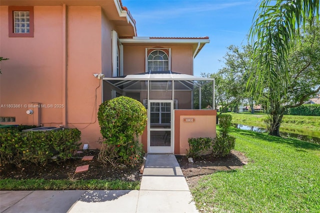 11832 Royal Palm Blvd, Coral Springs, FL 33065 - entrance to property with stucco siding, a lawn, and a water view