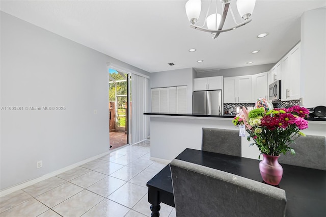 11832 Royal Palm Blvd, Coral Springs, FL 33065 - kitchen featuring appliances with stainless steel finishes, white cabinets, baseboards, recessed lighting, and a peninsula