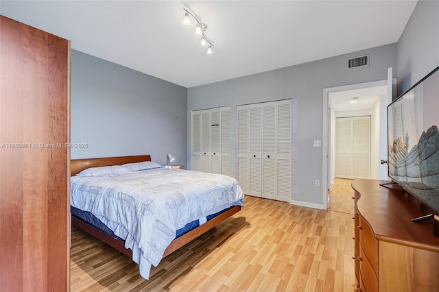 11832 Royal Palm Blvd, Coral Springs, FL 33065 - bedroom with multiple closets, light wood-style flooring, and baseboards