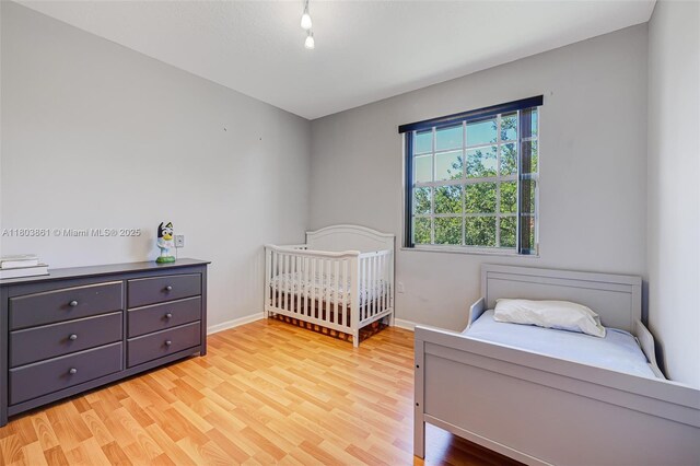 11832 Royal Palm Blvd, Coral Springs, FL 33065 - bedroom featuring light wood finished floors and baseboards