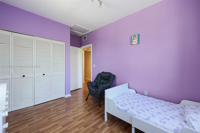 11832 Royal Palm Blvd, Coral Springs, FL 33065 - bedroom featuring wood finished floors, a closet, attic access, and baseboards