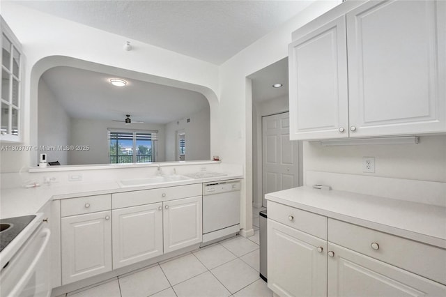 7739 Southampton Ter Unit 415, Tamarac, FL 33321 - kitchen with dishwasher, a sink, light tile patterned floors, glass insert cabinets, and white cabinetry