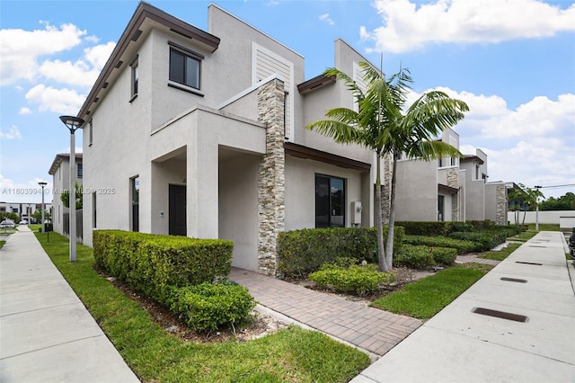 21408 NE 2nd Path, Miami, FL 33179 - view of property exterior featuring stucco siding and stone siding