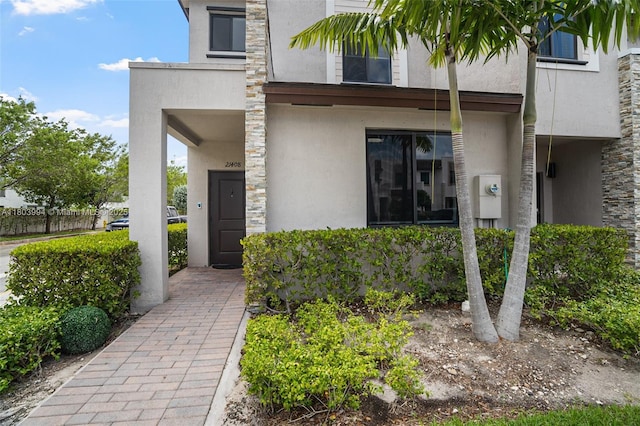 21408 NE 2nd Path, Miami, FL 33179 - doorway to property featuring stucco siding and stone siding