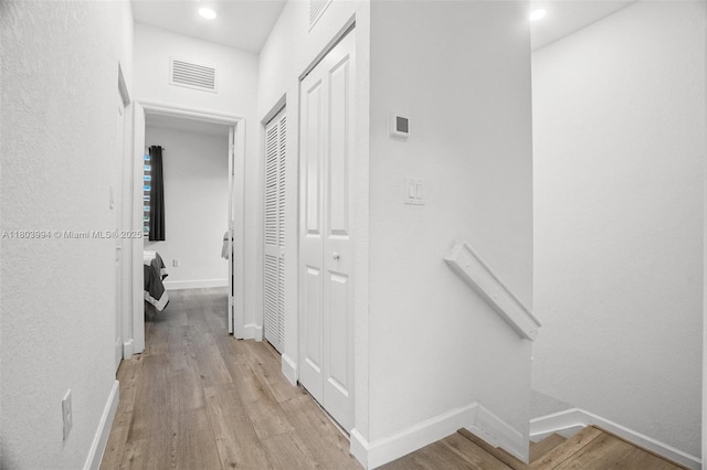 21408 NE 2nd Path, Miami, FL 33179 - hall featuring light wood-style flooring, an upstairs landing, baseboards, and recessed lighting