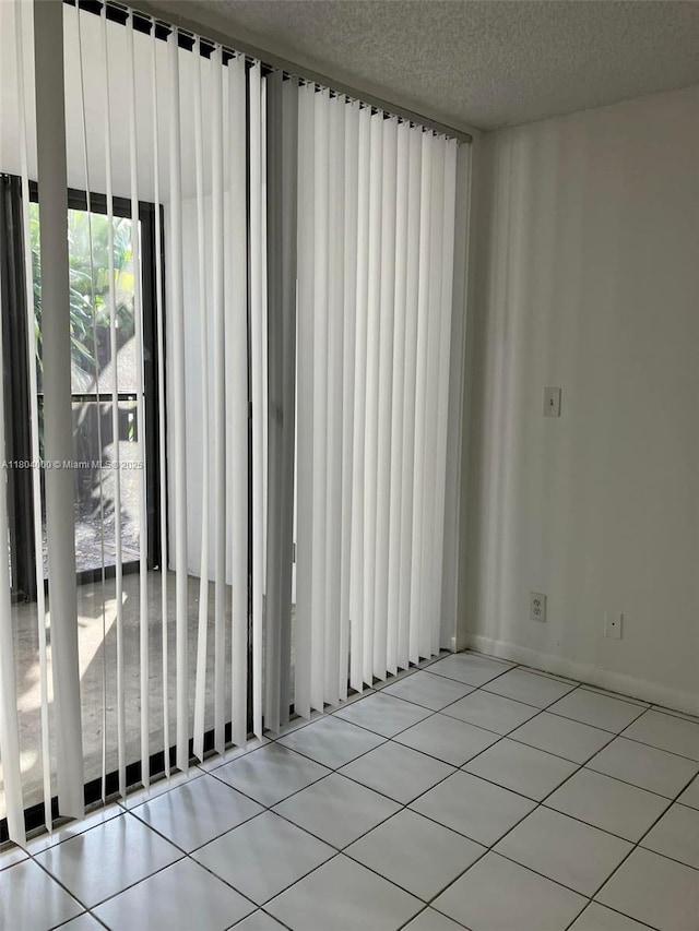 213 Lake Pointe Dr Unit 112, Oakland Park, FL 33309 - empty room with tile patterned flooring and a textured ceiling